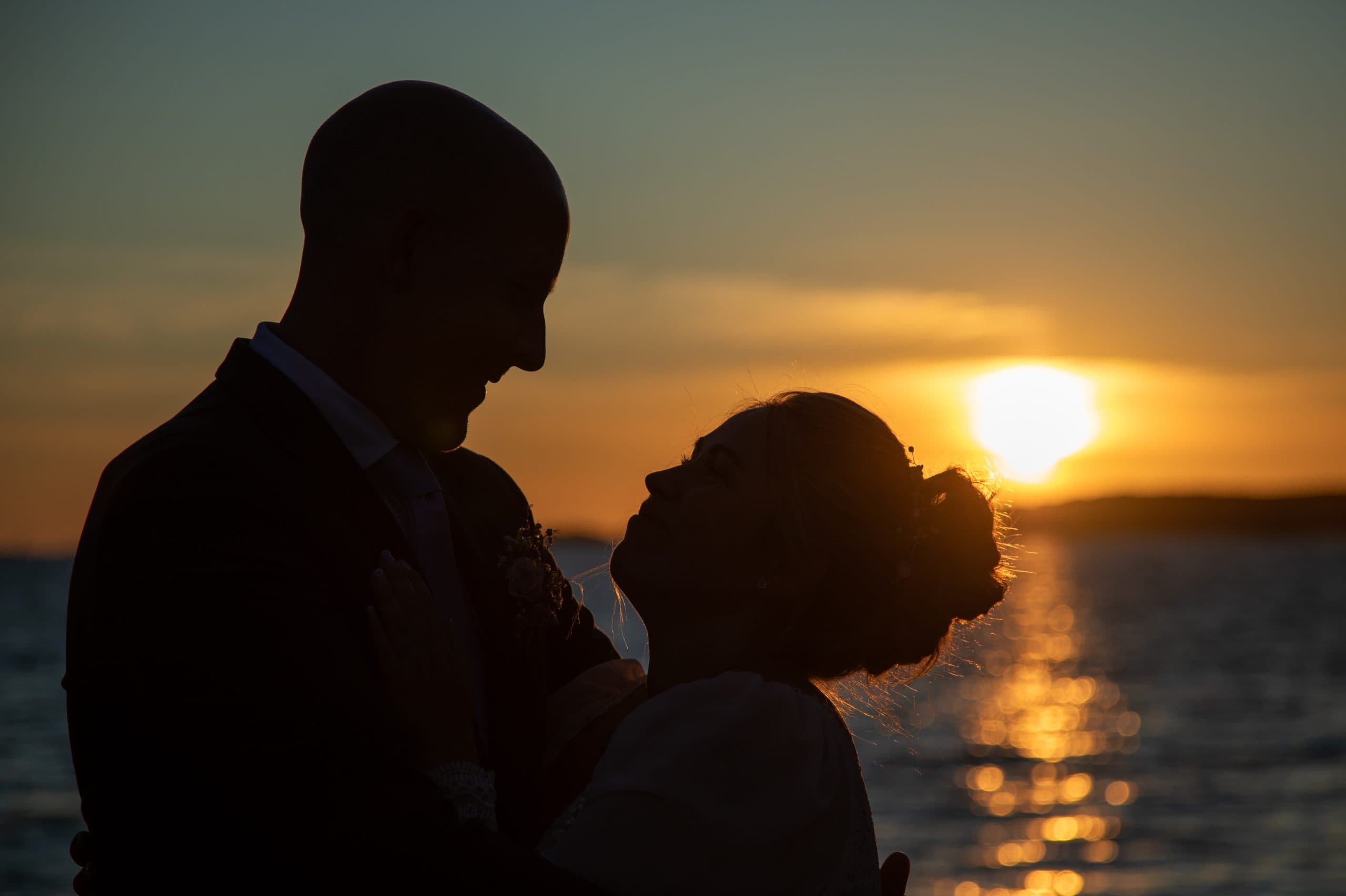 Romantic wedding couple silhouette against sunset